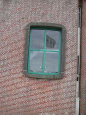 window in red brick wall glass