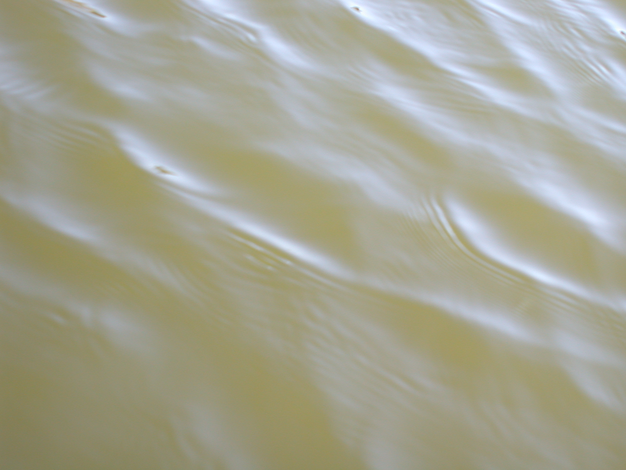 brown dirty clouded water little waves surface