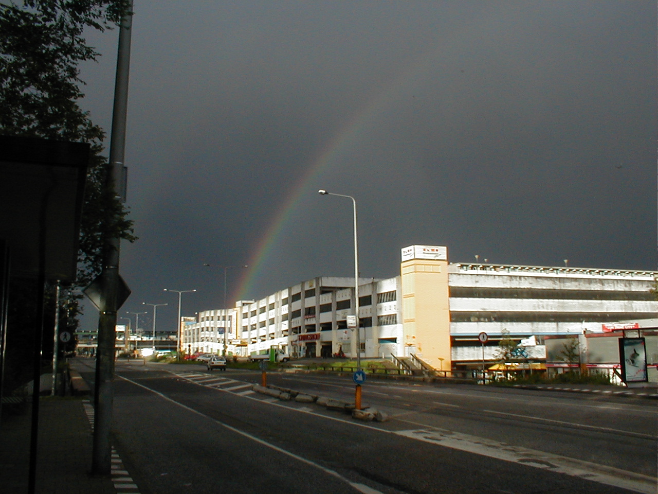 dario rainbow dark sky bad weather highway road building