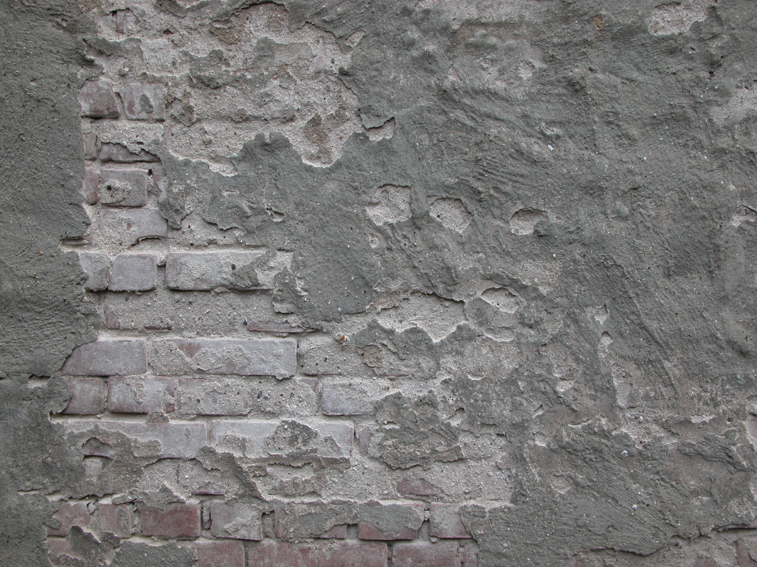 wall mortar cement peeled away bricks underneath showing