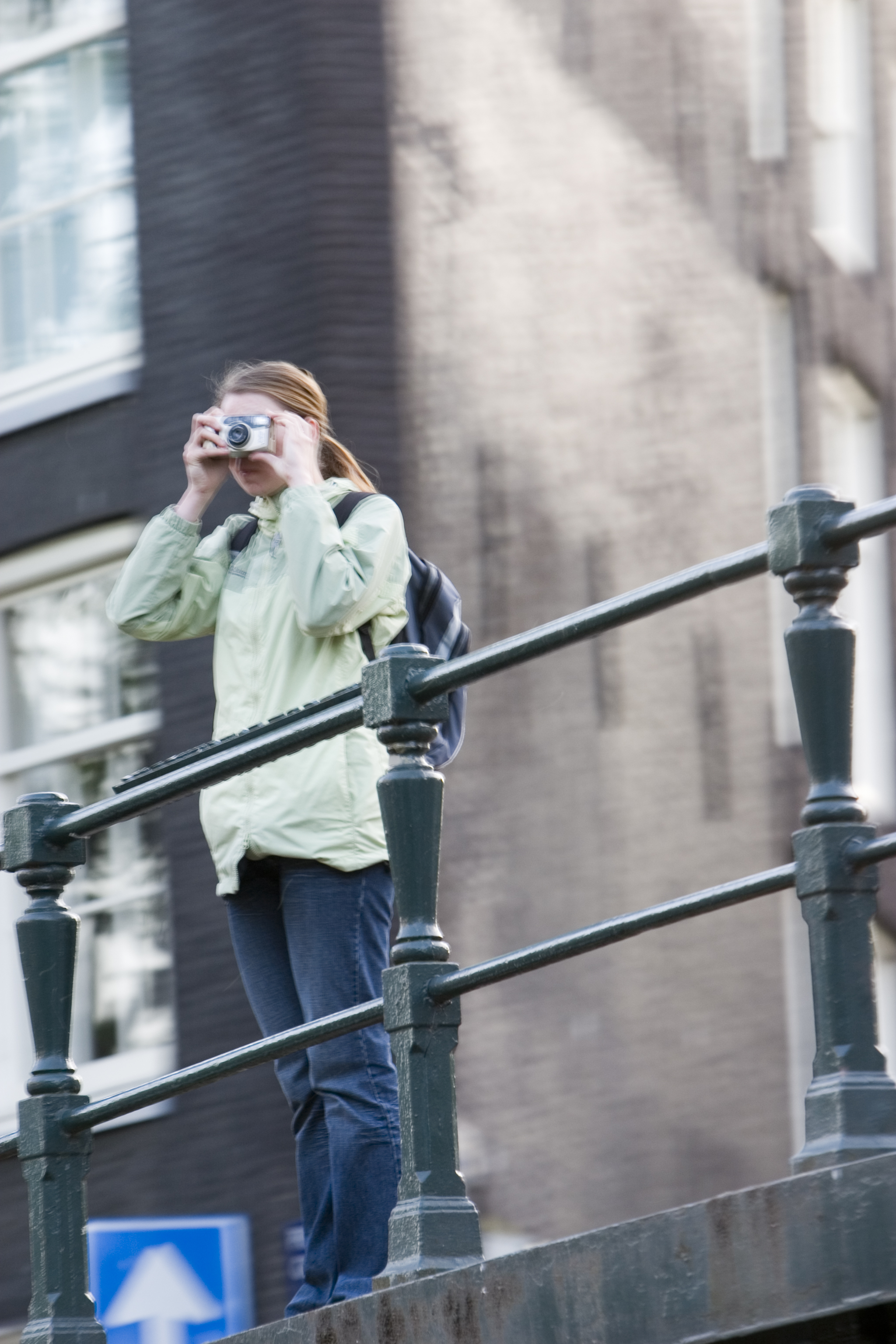 characters humanoids woman photographer taking photograph touris amsterdam bridge backpack