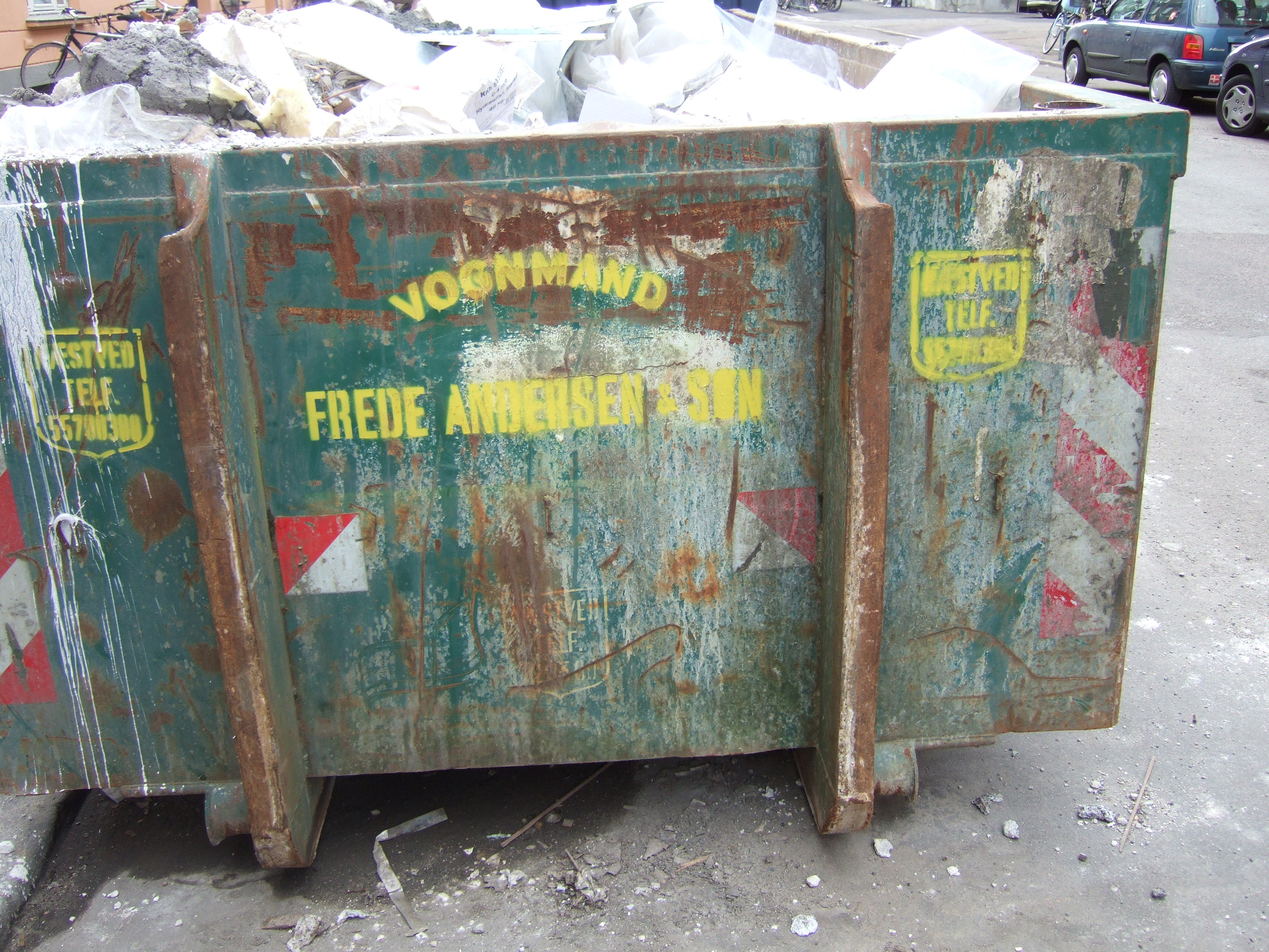 tabus garbage container green dump rubble stones construction