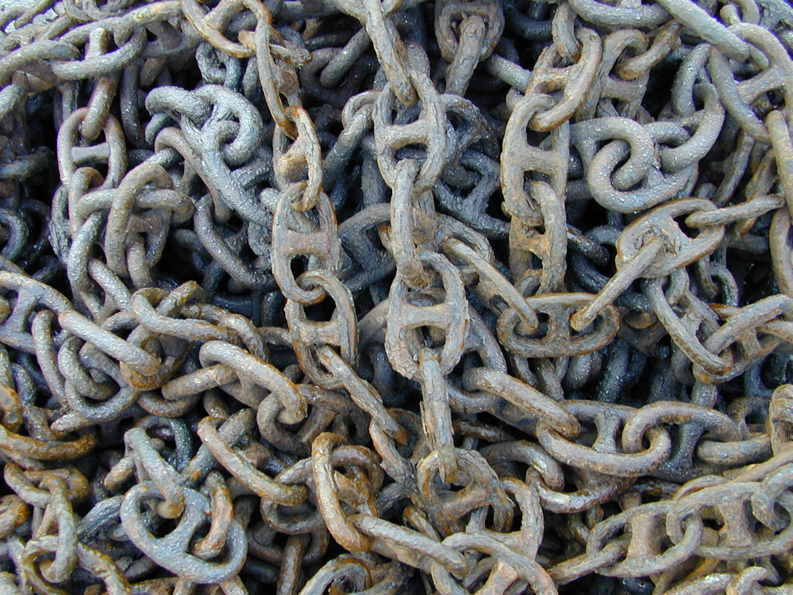 wet chains coil heap metal rusty chain