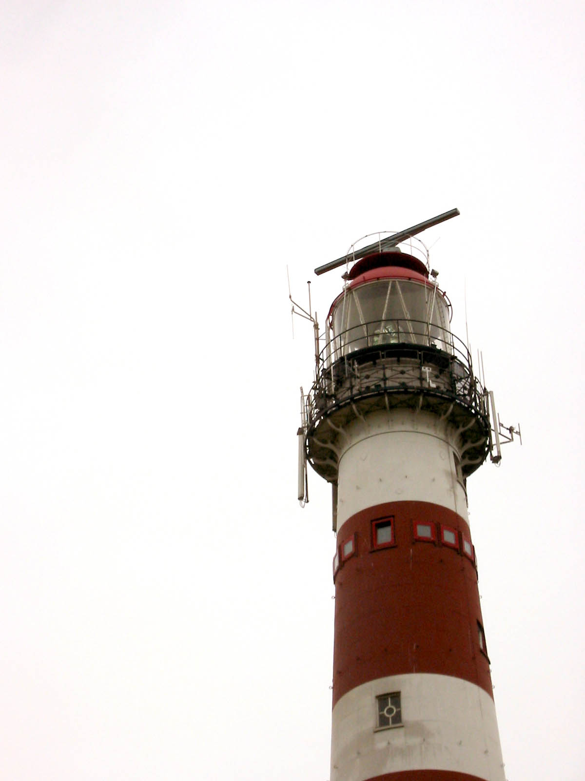 lighthouse red white and stripes shipping tall building top