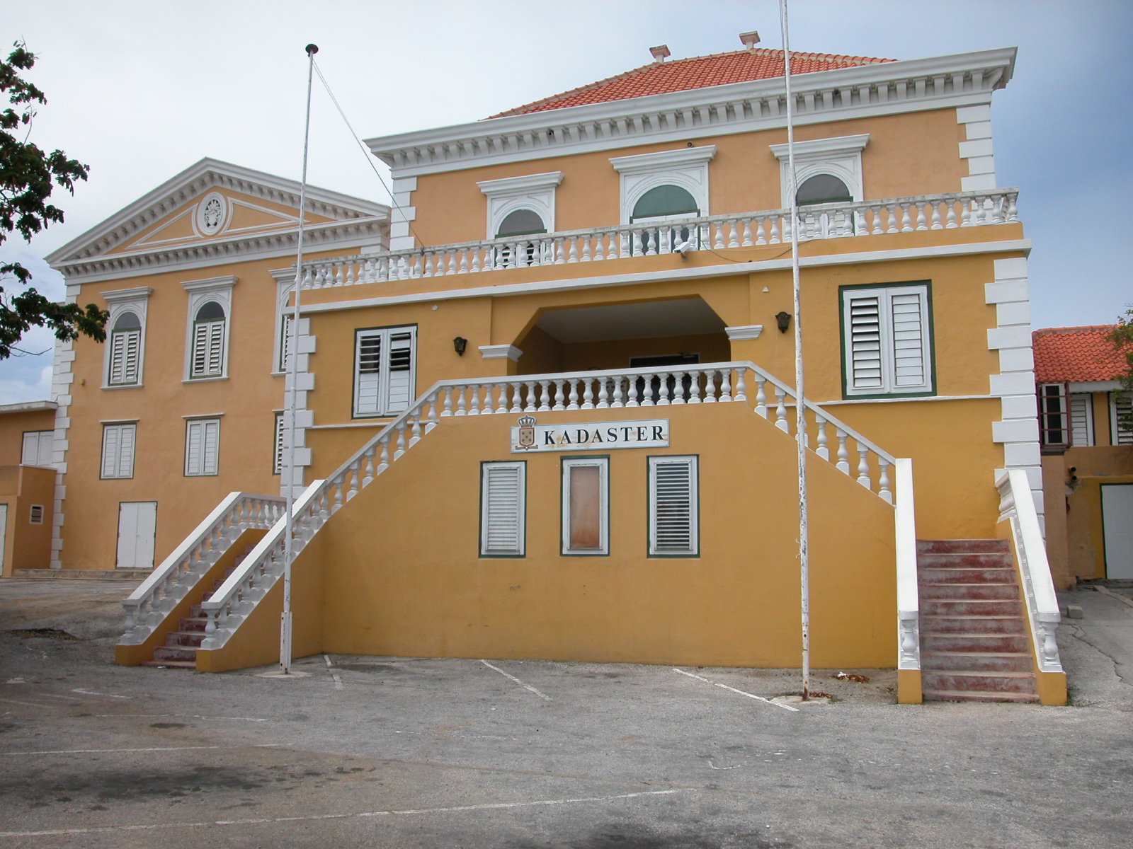 jacco kadaster townhall yellow painted house villa flagpoles balcony royalty-free