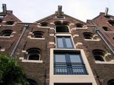 building warehouses amsterdam city architecture exteriors arches windows hoist ornaments