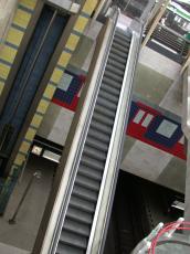 escalator stairway flight flights of stair stairs iron silver silvery mall shopping center