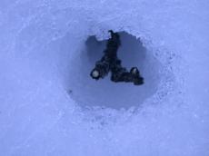 ice snow cover covered blanket ground cold winter white crystal crystals hole twig of wood poking thorugh thru