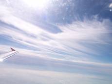 dario wispy clouds soft white blue sky airplane wing tip