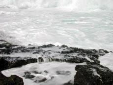 spray foam foamed foaming shore white fluffy rock rocks cliff cliffs breaking