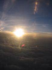 sun from an airplane window clouds sunset dawn dusk morning evening