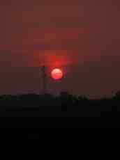 sunset red setting sun television mast broadcasting dark evening darkening