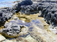 rocks rocky craggy cliff cliffs water pool shallow