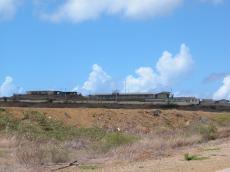 whatchtower complex buildings sunny fence blue sky