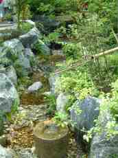 maartent asian japanese garden water bamboo pipe rocks pebbles stream