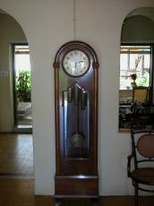 old wooden grandfather grandfather's clock timekeeper hands point at half past two stately