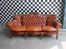 leather couch old old-fashioned fashioned comfy decorated woodcuttings woodcutting brown leathery