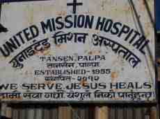 united mission hospital we serve jesus heals sign asian rusty script