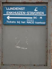 blue sign on metal door
