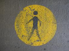 scripts human figure circle sign yellow concrete footpath