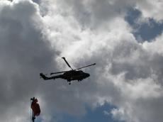 helicopter navy army grey skies rotors flagpost stormy