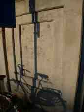 shadow shadows against wall bike bycicle stone slab dusk
