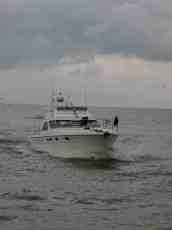 yacht boat expensive white water sea spray grey gray 