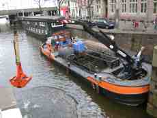 barge grabbing canal bed grabber emptying