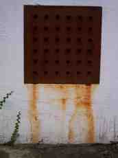 dario grate grating metal hole wall rust brown