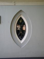 almond shaped window wall grey plaster