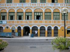 arc arces building front yellow pillars